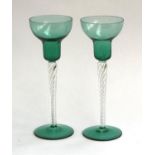 A pair of green glass and spiral airtwist stemmed candlestick holders, 21cmH