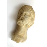 A carved marble bust of a Grecian man wearing a laurel wreath, 16cm high