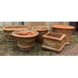 Five terracotta plant pots, two made by Whichford Pottery, the largest pot 40cmD with lattice design
