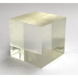 A large perspex cube, approx. 15x15x15cm