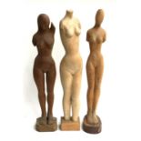 Three carved wooden nude sculptures, the largest 73cmH