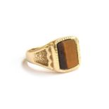 A 9ct gold signet ring set with tigers eye, size Q 1/2, 5.8g