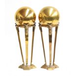 Interior design interest: a pair of brass orbs on triform stands with applied ram mask detail, 26cmH