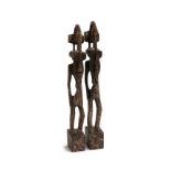 A pair of Sefuno tribe carved wood figures, patinated finish, 49cmH