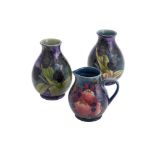 A pair of Moorcroft 'Black Tulip' pattern vases, late 20th century, tubeline decorated, each 19cm