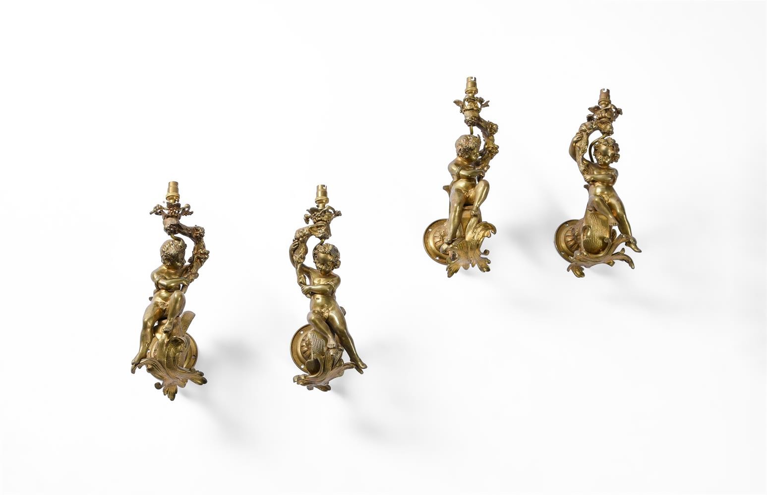 A set of four early 20th century gilt metal wall appliques in French late 18th century taste, each