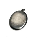 A large oval silver locket, marked 'STERLING', 7cm high