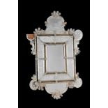 A Venetian moulded and etched glass wall mirror, late 19th century, with shaped arched top over a