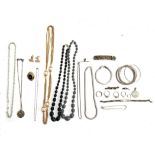 A mixed lot of jewellery to include a white metal hair slide set with multi coloured paste and