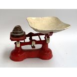 A set of red painted vintage kitchen scales and weights