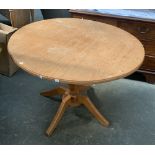 A vintage oak and elm circular dining retailed by St. Michael, on turned column base and four