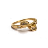 An 18ct gold and baguette cut diamond ring, size O 1/2, 3.1g