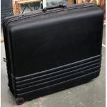 A large hard suitcase by Newest, with combination lock and wheels