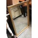 A decorative gilt framed rectangular mirror with bevelled glass, 95x64cm