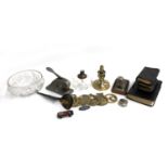 A mixed lot to include glass oil lamp, desk stamp, various horse brasses, a velos no. 323, horn