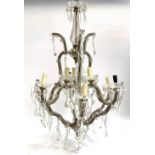 A large glass and wrought iron nine light fitting chandelier with cut glass drops, 80cm high