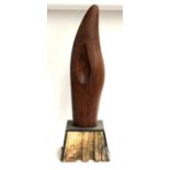 A large abstract carved wooden sculpture, plinth af, 91cmH