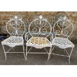 Three heavy white painted wrought iron garden chairs