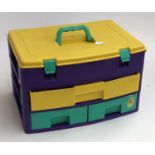 A child's plastic storage case containing pens and art supplies