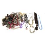 A mix of costume jewellery, including faux pearls, bakelite-type necklace, etc.