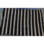 A black camel hair rug with brown and white stripes, 205x135cm