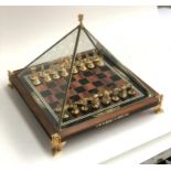 A Franklin Mint 'Treasures of Tutankhamun' gold plated and enamelled chess set within a glass