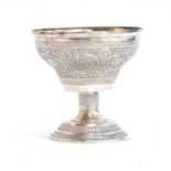 An Eastern white metal goblet, chased with scrolling foliate detail, on a chased stem and