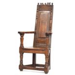 An early 18th century oak wainscot chair, carved cresting over an unusually narrow back, inscribed '
