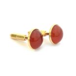 A pair of 10ct gold cufflinks set with carnelian cabochons, 1.3cm diameter, marked '10k Diana',