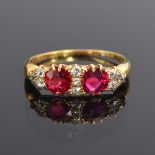 A late 19th/early 20th century ruby and diamond ring, the two rubies totalling approx. 0.9ct, size