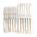 A set of Edwardian silver and mother of pearl handled fruit knives and forks for six place settings,