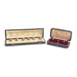 A cased set of mid Victorian gold buttons, of engraved knot form, tests as 15ct or higher, gross