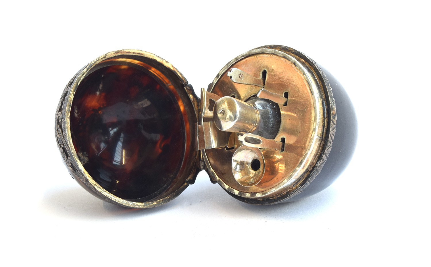 A 19th century tortoiseshell and pique egg shape necessaire, the hinged cover decorated with a spray