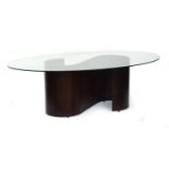 A Tom Schneider 'wave' dining table, the oval glass top on an S scroll base