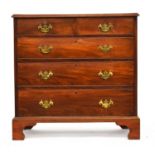 A George III mahogany chest of two short over three graduating drawers, on later bracket feet,