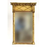 A Regency gilt framed wall mirror, projecting cornice with ball and lattice frieze, upright plate
