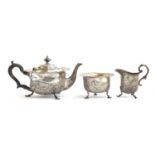 An Edwardian chased silver teapot and sugar bowl by George Nathan & Ridley Hayes, Chester 1904 and