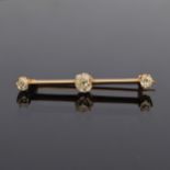 An early 20th century gold and diamond bar brooch of knife edge form, the largest diamond approx.