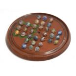 A late 19th/early 20th century solitaire board with 32 mainly 19th century marbles with internal