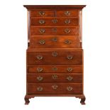 A George III mahogany and parcel gilt chest on chest, c.1770, the dentil cornice over two short