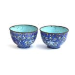 A pair of Chinese Canton enamel cups, cobalt blue ground decorated with scrolling florals,