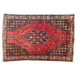 A red ground Mazlaghan rug, central serrated lozenge, 190x124cm