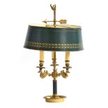A gilt brass bouillotte lamp with adjustable green tole shade over three fittings, each supported on