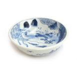 A Chinese blue and white bowl, the interior decorated with floral panels, sparrows on a river bank