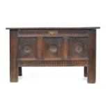 A late 17th/early 18th century oak three panel coffer, each panel carved with central apotropaic