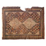 A Persian rug, 20th century, with two serrated lozenges (damage), 186x141cm