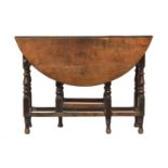 An oak gateleg table, early 18th and later, the circular top raised on eight baluster turned