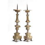 A pair of 18th century Italian brass pricket candlesticks, with knopped stems and triform bases,