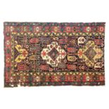 A cut down colourful Persian rug, 181x114cm