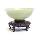 A very large Chinese jade bowl, with carved Greek key border, 29cm diameter and 10.5cm high, on a